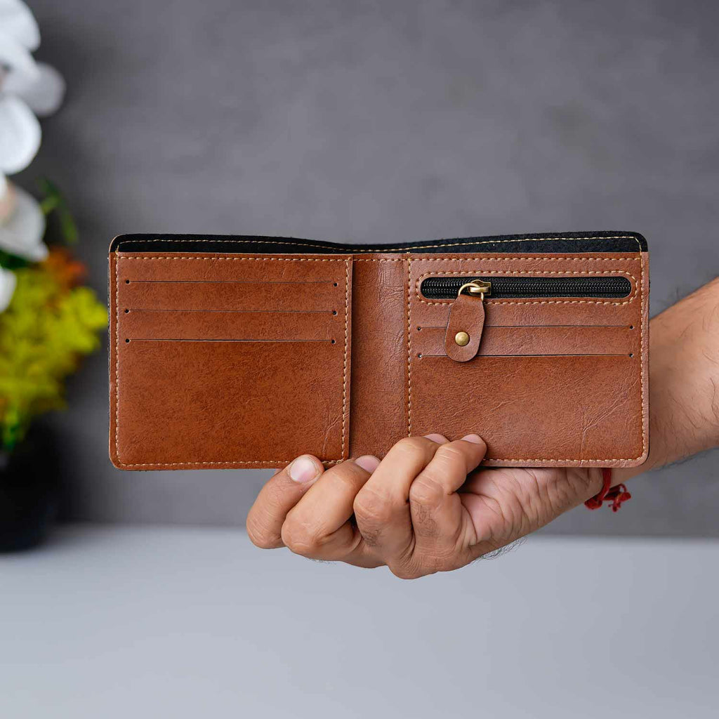 Brown leather wallet held by a hand | Zestpics